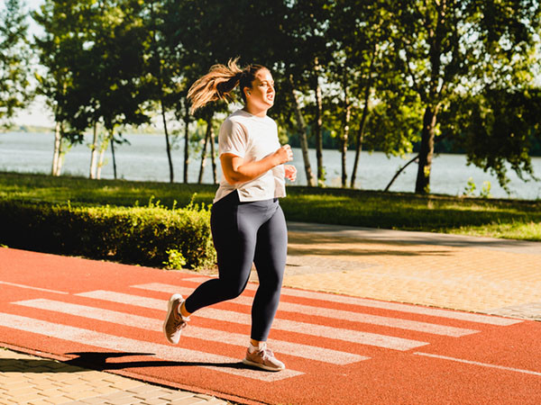 woman running outdoors in sunlight